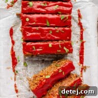 A top-down square image of a beautifully glazed vegan lentil loaf, ready to be sliced and served.