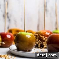 Appetizing vegan caramel apples, a classic festival treat, some with nuts and some without, offering a delightful customizable indulgence.