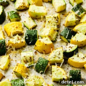 Summer squash and zucchini in chunks, cooked on tan paper.