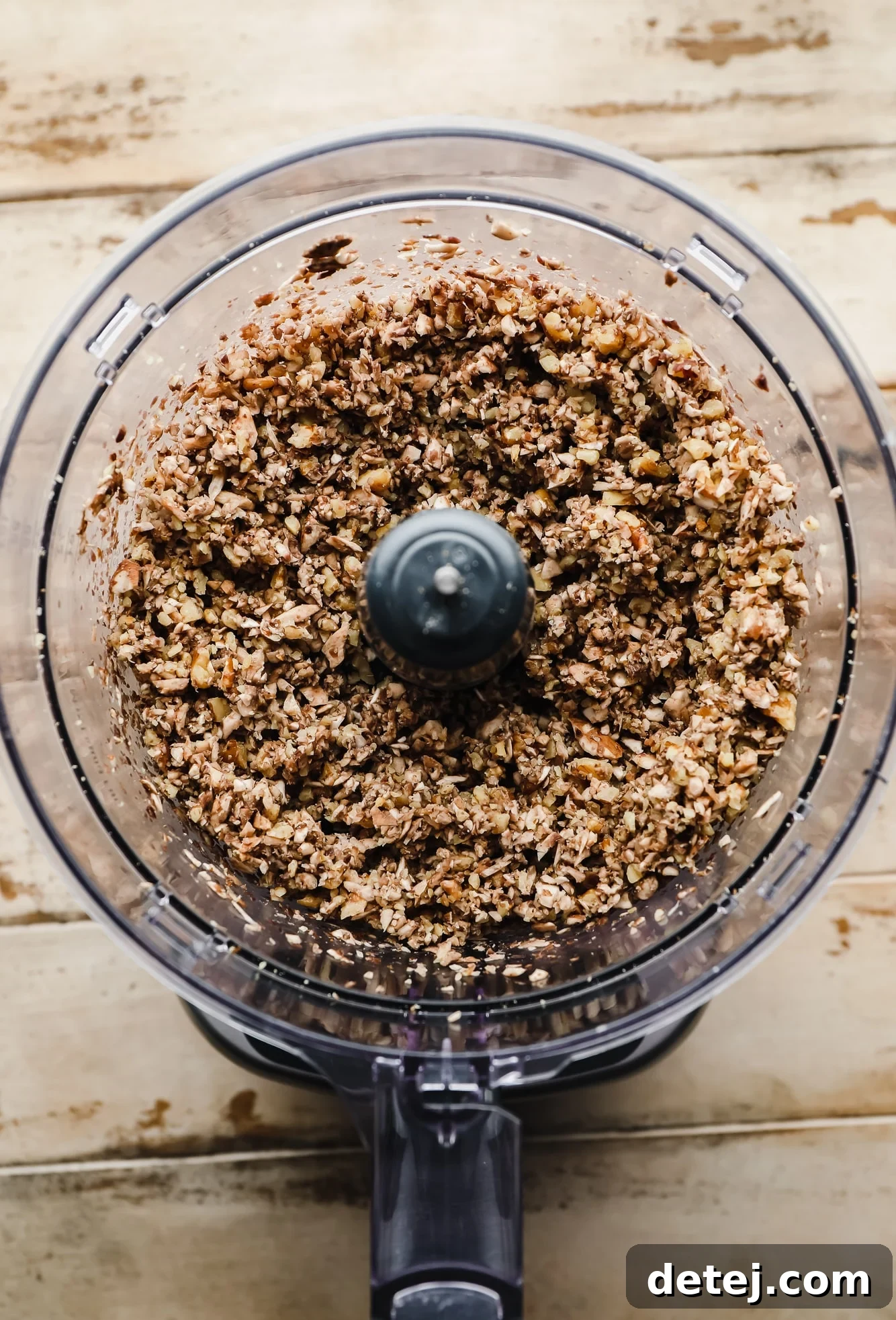 Your New Favorite Vegan Tacos 4 Crumbled walnuts and mushrooms inside a food processor bowl, showing the ideal texture before cooking for the vegan taco meat.