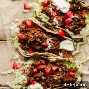 Your New Favorite Vegan Tacos 8 Three beautifully assembled vegan tacos lined up, showcasing the rich mushroom and walnut 'meat' filling topped with fresh ingredients.