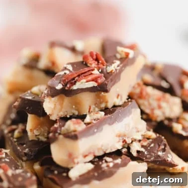Vegan toffee with chocolate and nuts, and a pink towel in the background, indicating a cozy, homemade treat.