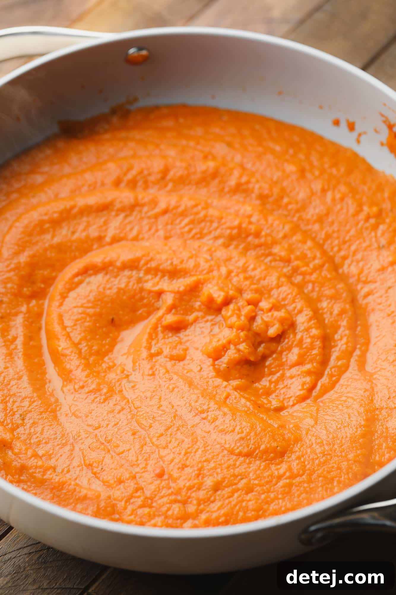 close up on pumpkin pasta sauce in a large skillet.