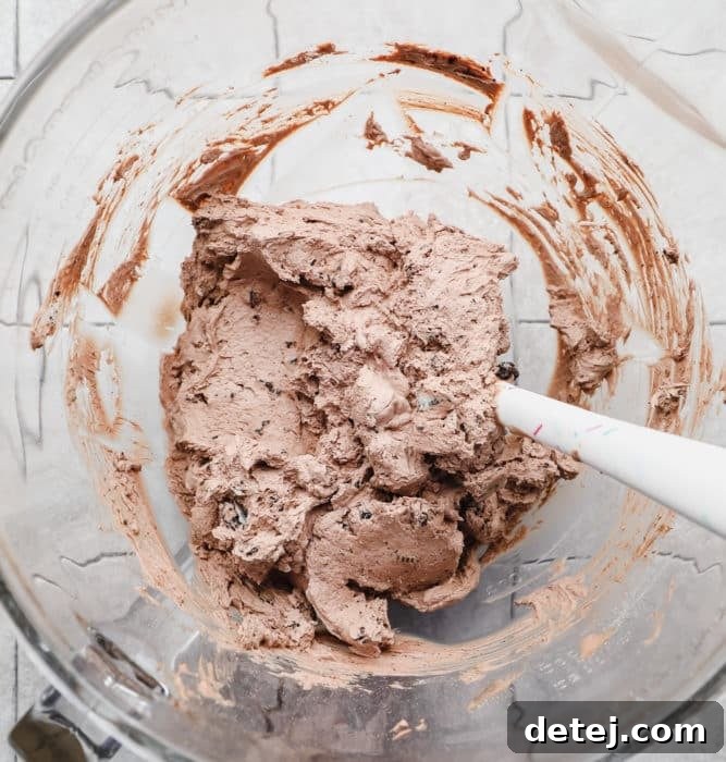 chocolate whipped frosting in a bowl with spatula.