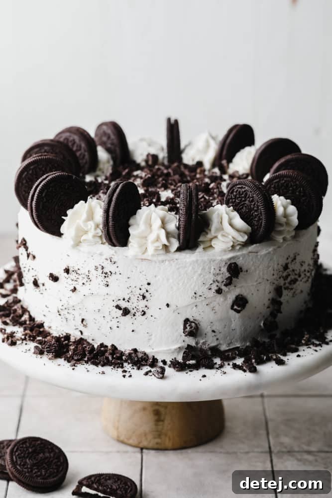 whole oreo cake with white frosting and lots of cookies on top.