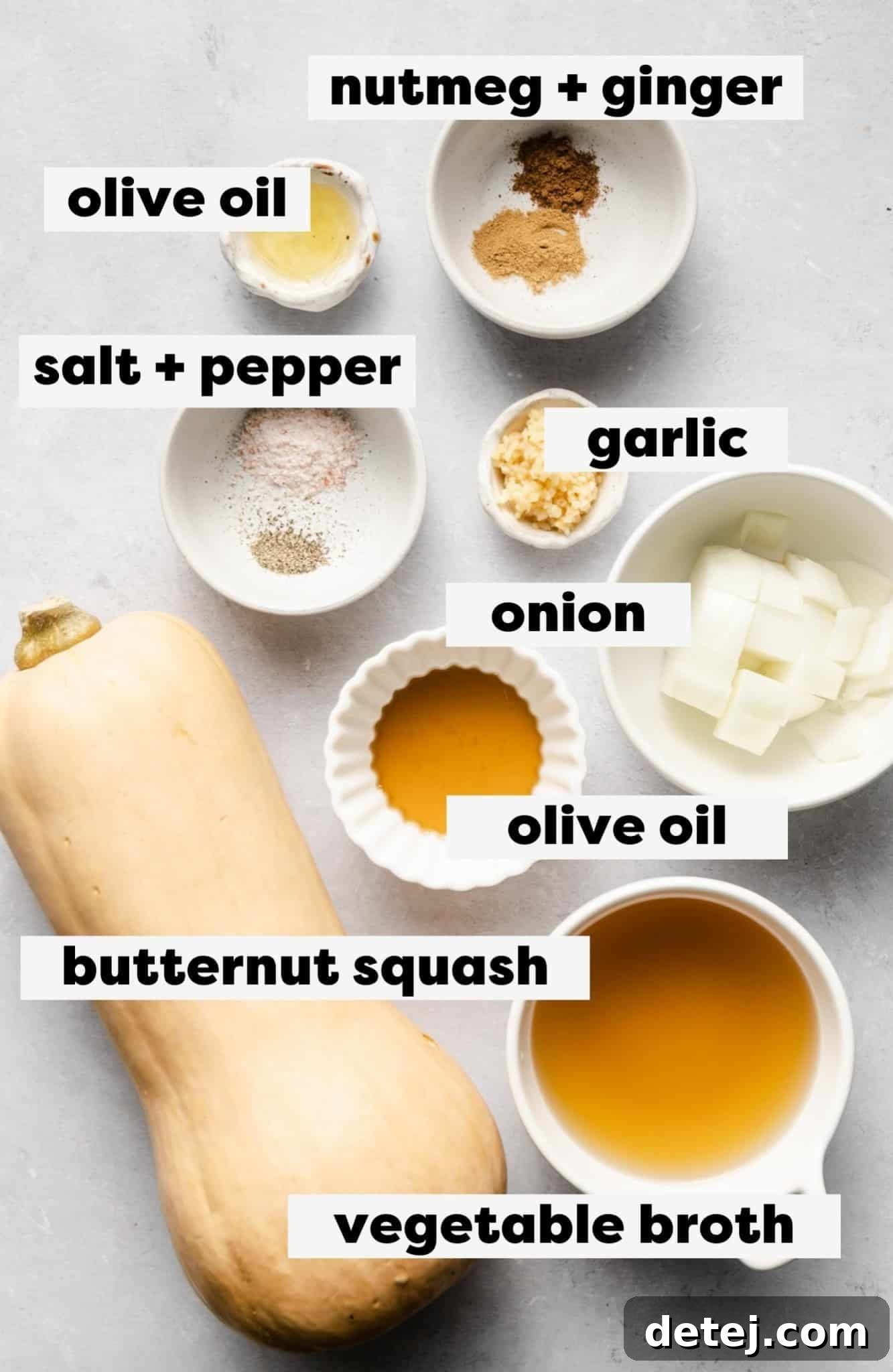 Individual white bowls filled with the fresh ingredients required for making creamy butternut squash soup.