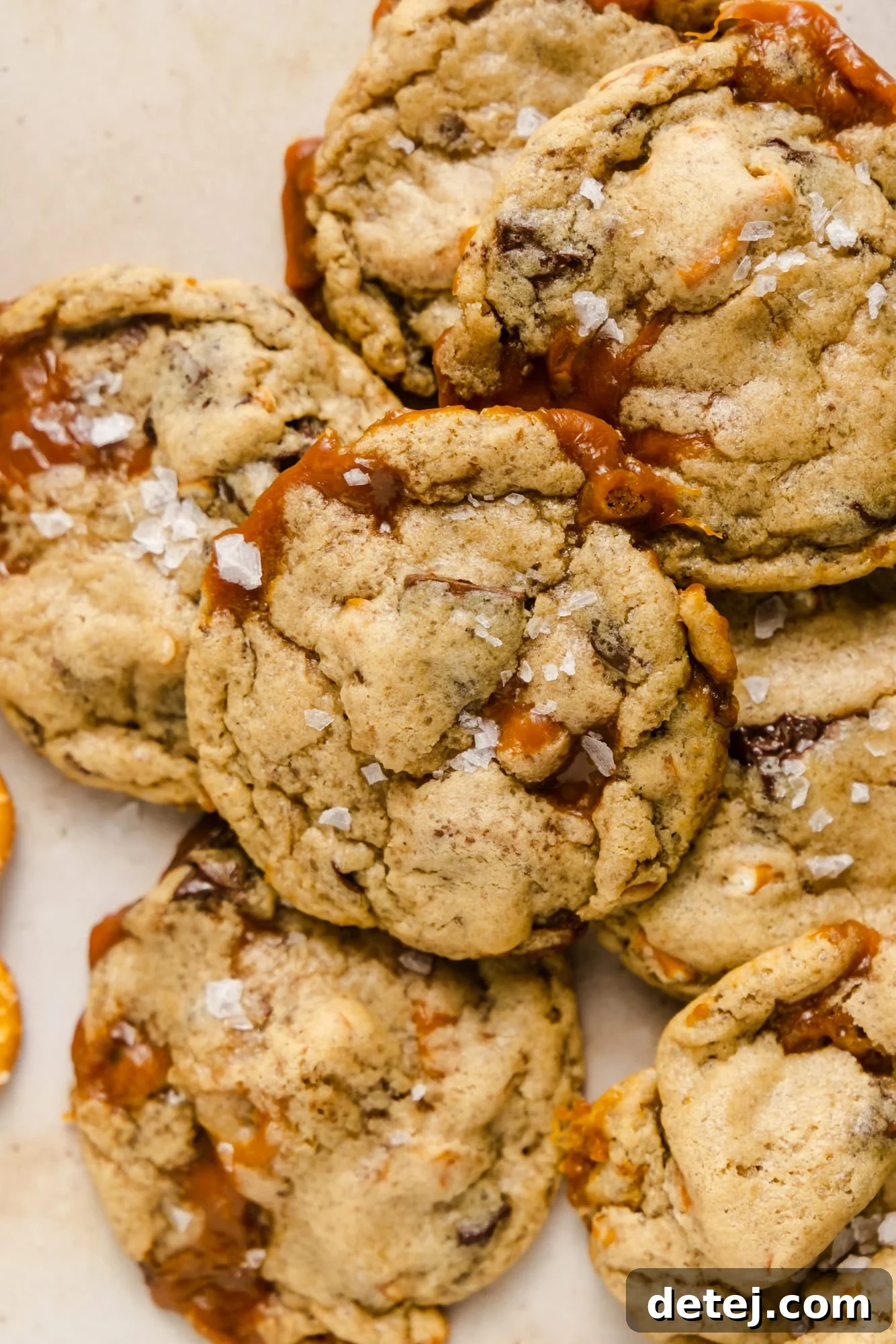 Close-up of freshly baked vegan kitchen sink cookies, showcasing their golden-brown edges and delicious medley of chocolate, caramel, and pretzel pieces.