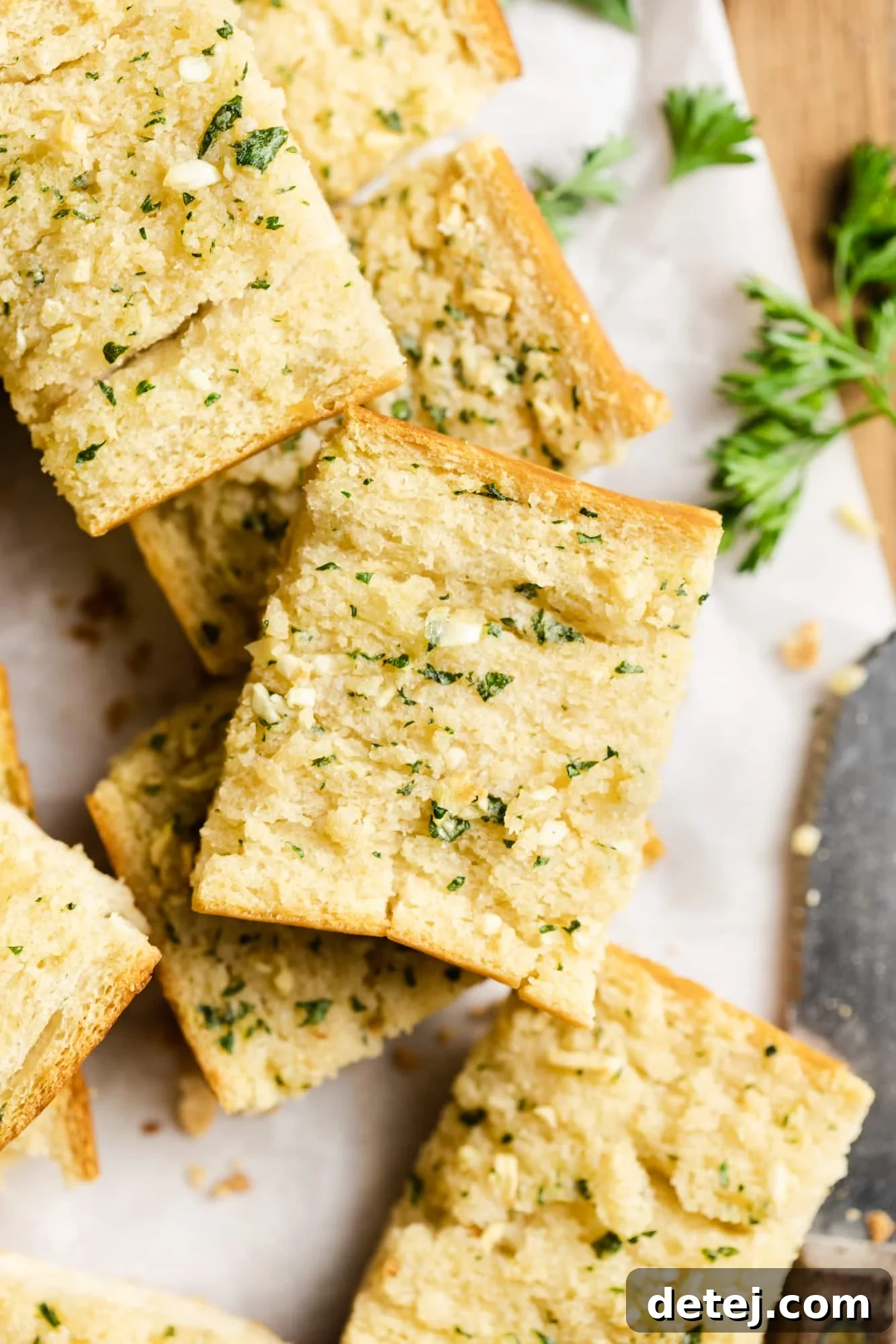 close up on pieces of baked vegan garlic bread on top of each other.
