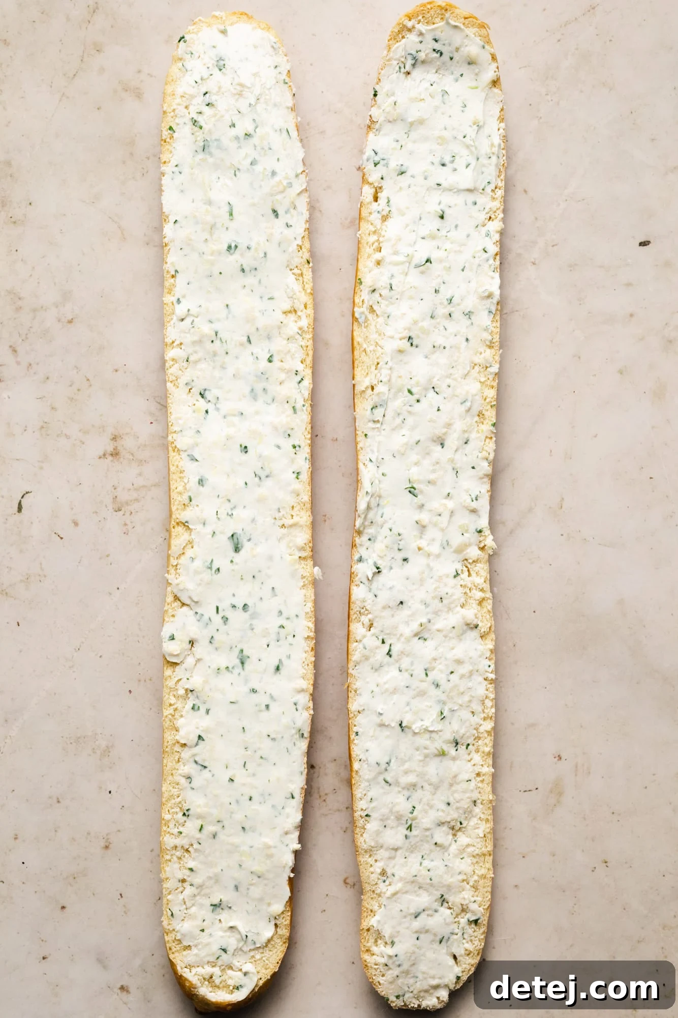 2 long halves of bread topped with garlic butter.