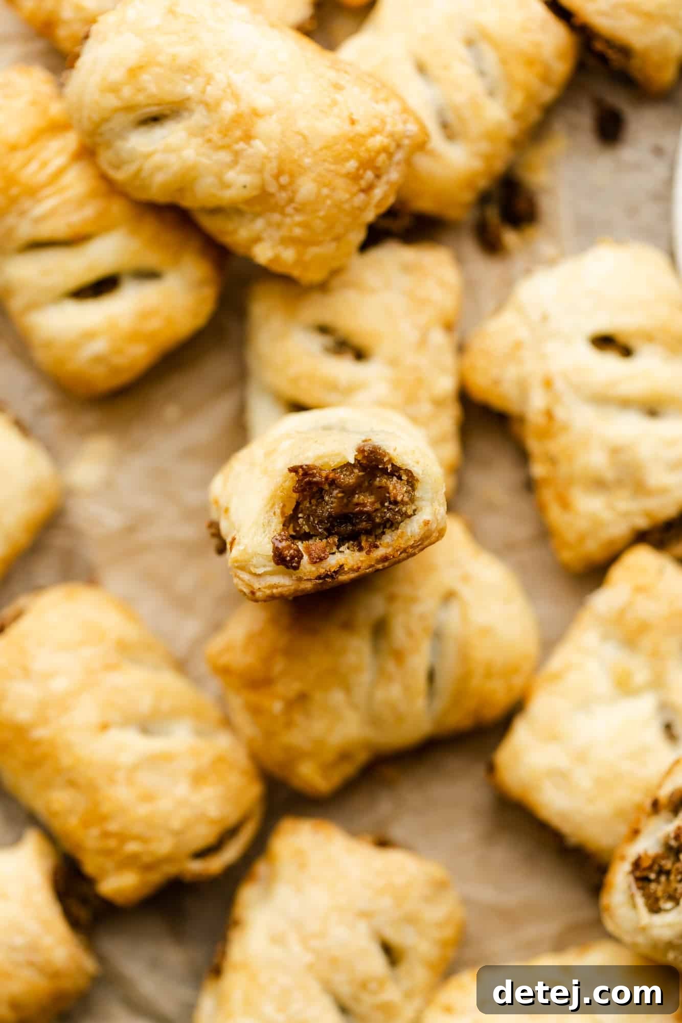 A beautifully arranged pile of golden-baked vegan sausage rolls, ready to be served.