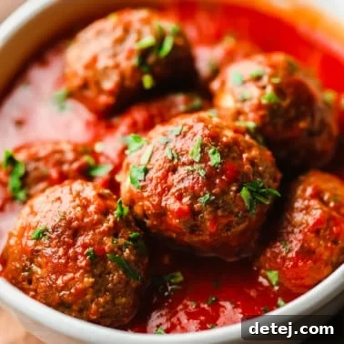 Next-Gen Meatballs 10 Vegan meatballs covered in marinara sauce in a white bowl.
