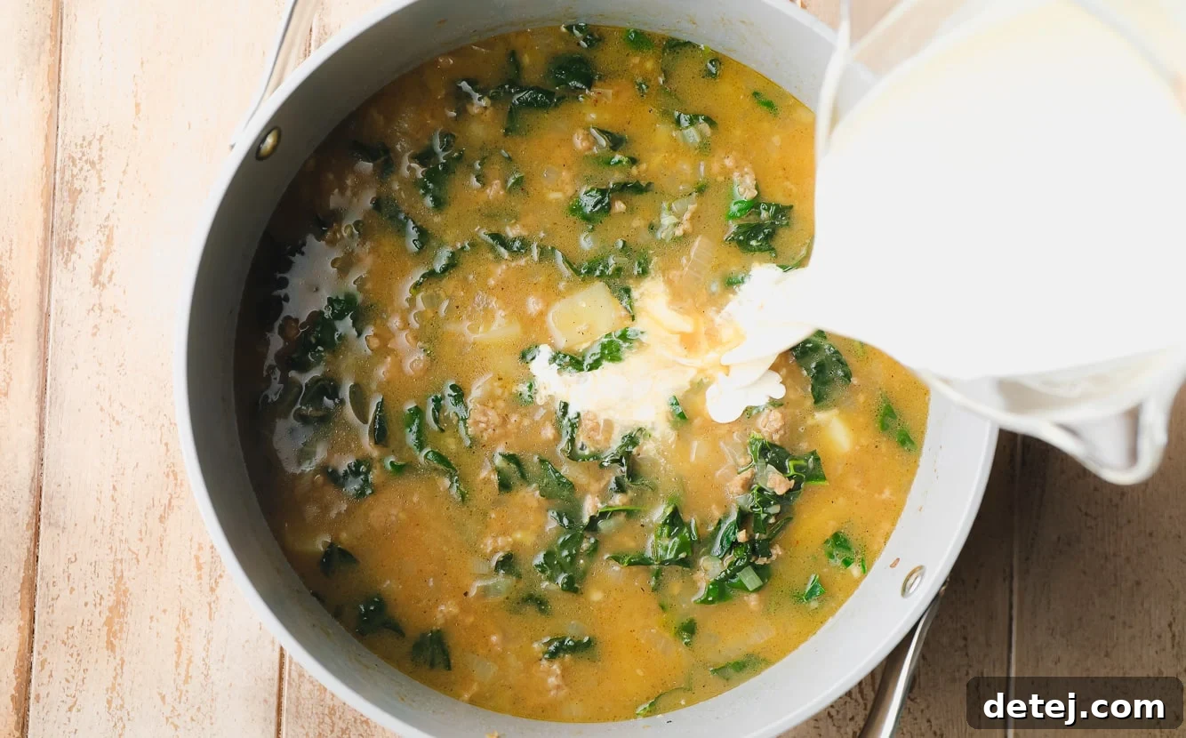 pouring cream into a pot of zuppa toscana soup.