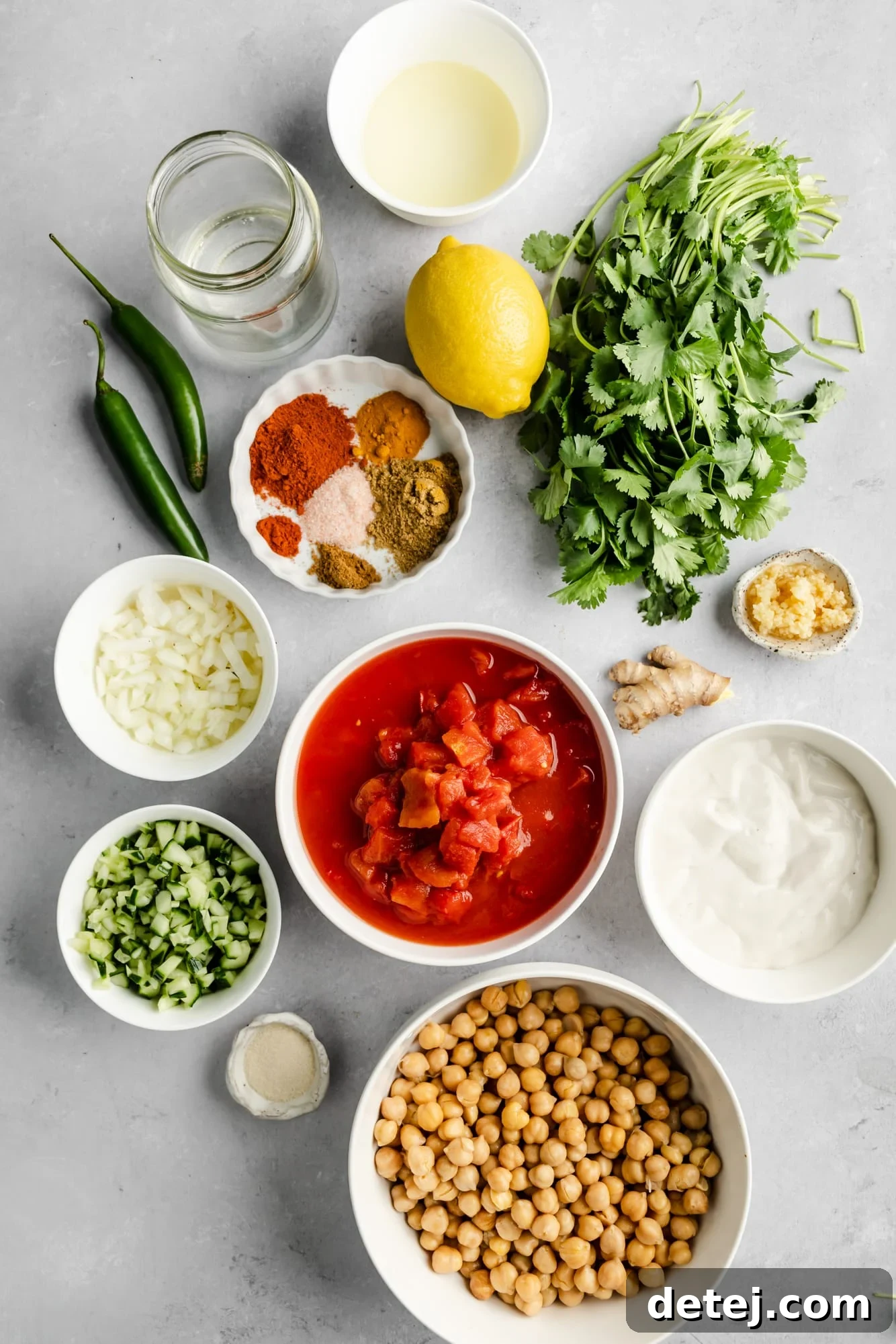 ingredients for easy chana masala in individual white bowls.