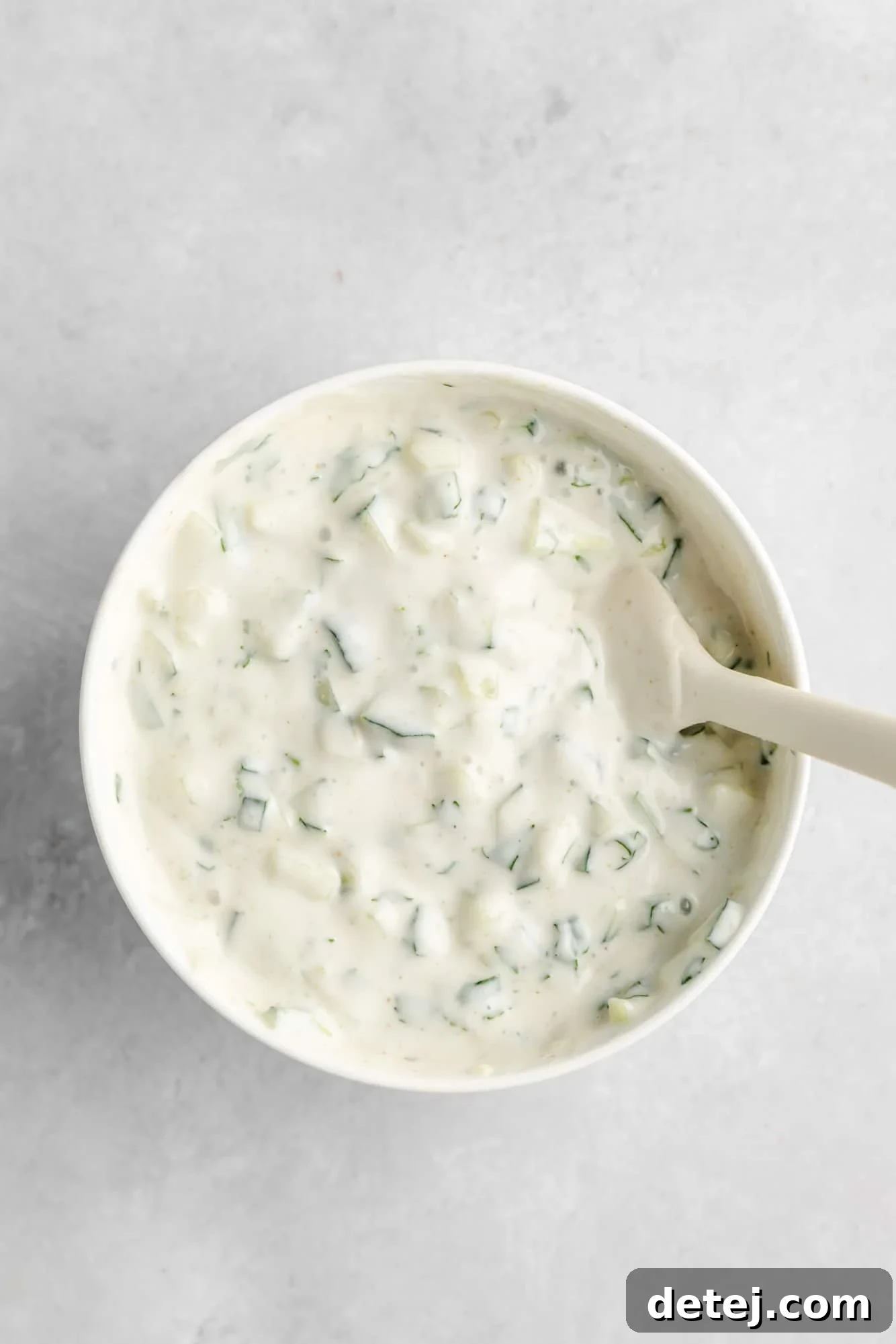 a creamy vegan yogurt sauce in a white bowl.
