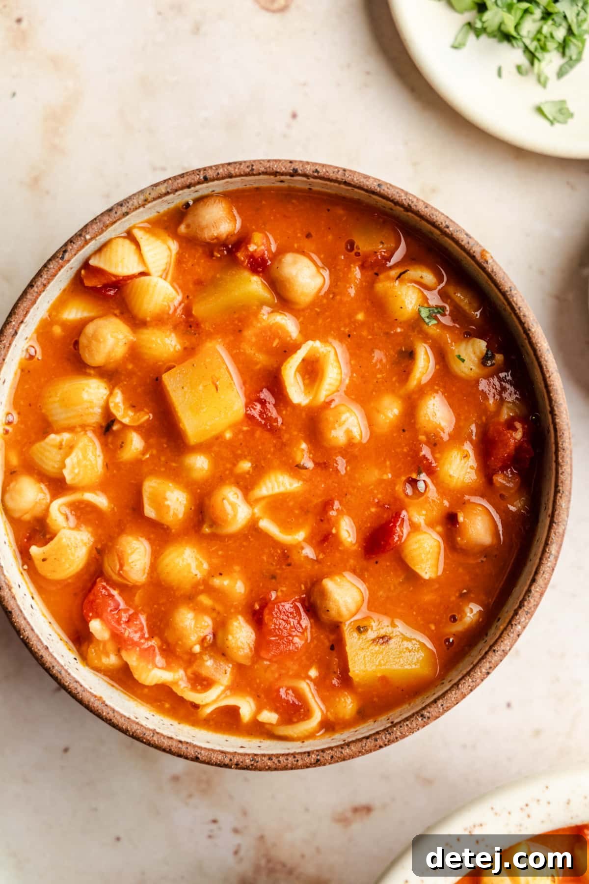 A beautifully presented bowl of Italian chickpea soup, ready to be enjoyed as a hearty and comforting meal.