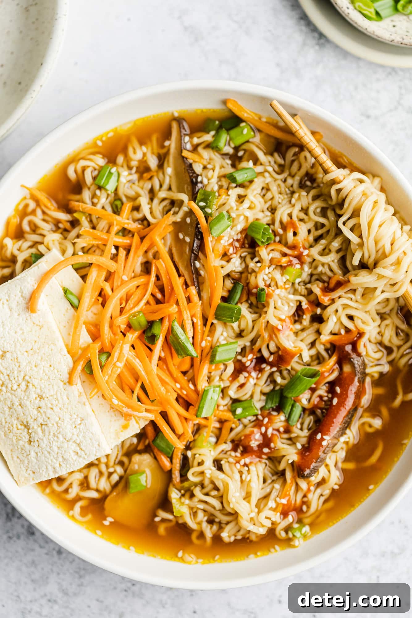 A beautifully presented bowl of vegan ramen, featuring colorful toppings and inviting steam, ready to be enjoyed.