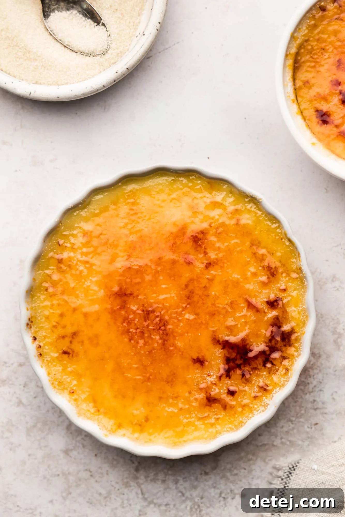 Vegan creme brulee in a white ramekin with a perfect caramelized sugar topping.