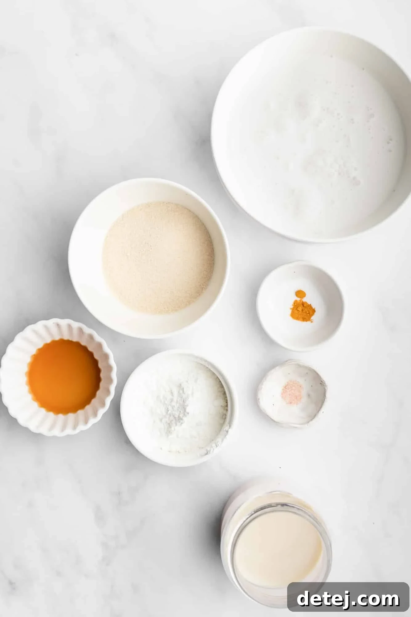 Ingredients for vegan creme brulee in individual white bowls, neatly arranged.
