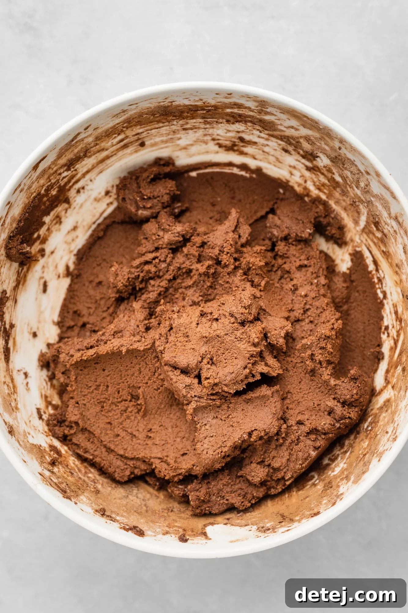 Vegan chocolate sugar cookie dough in a large white bowl.