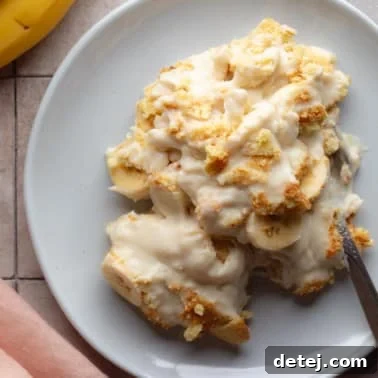 A delightful serving of vegan banana pudding on a plate with a spoon, ready to be enjoyed.
