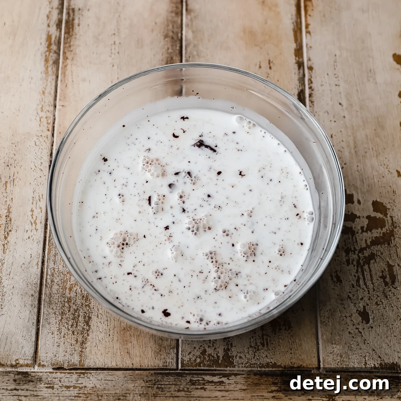 coconut milk and chopped chocolate in a glass bowl.