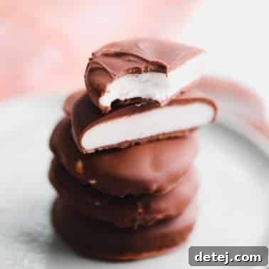A stack of vegan peppermint patties cut in half on a small plate.