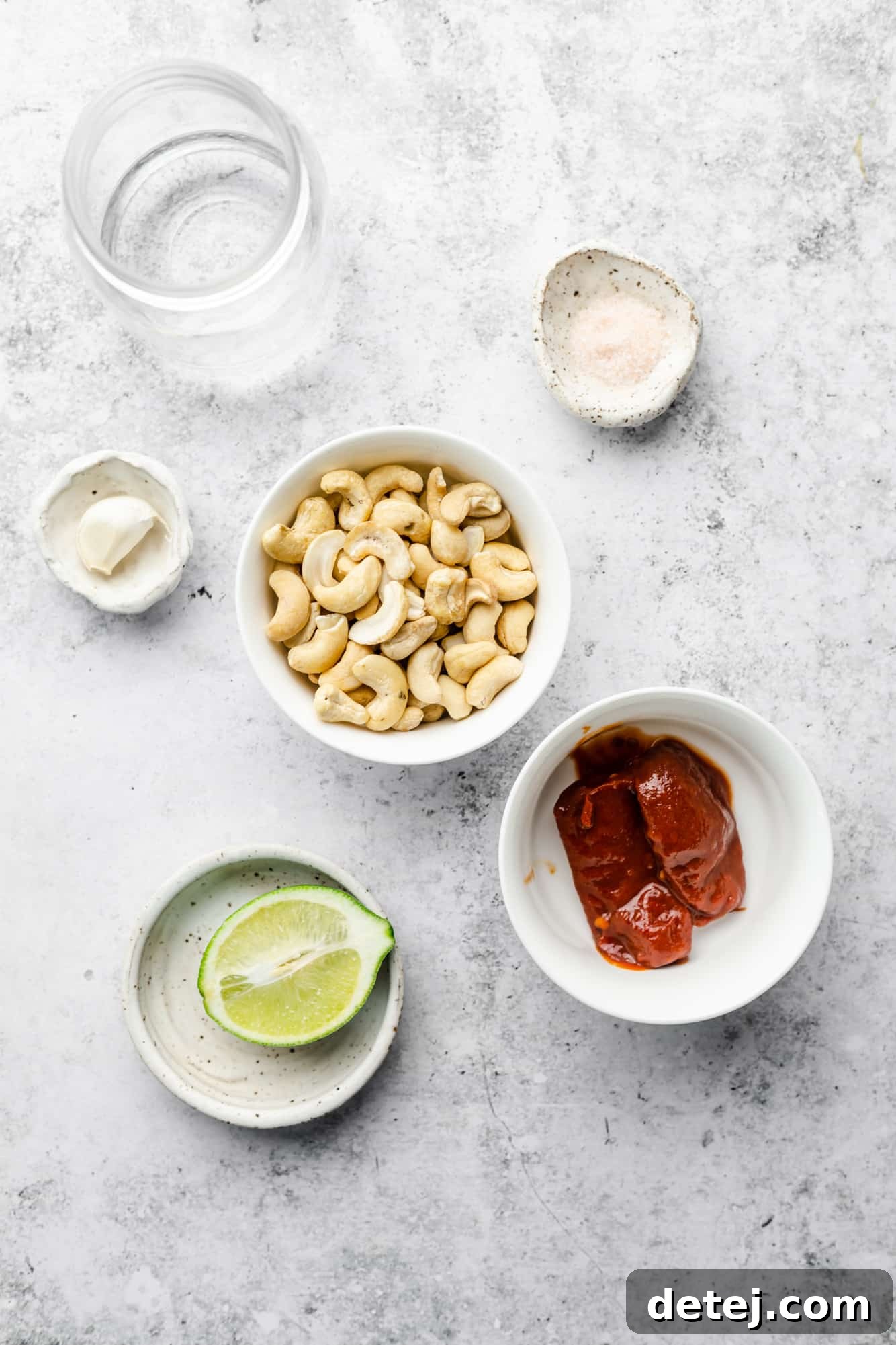 Smoky Chipotle Magic 3 Individual bowls and glasses displaying the fresh ingredients required to make homemade chipotle sauce.