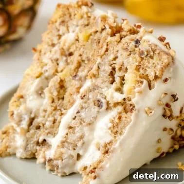 close up on a slice of vegan hummingbird cake on a grey plate.