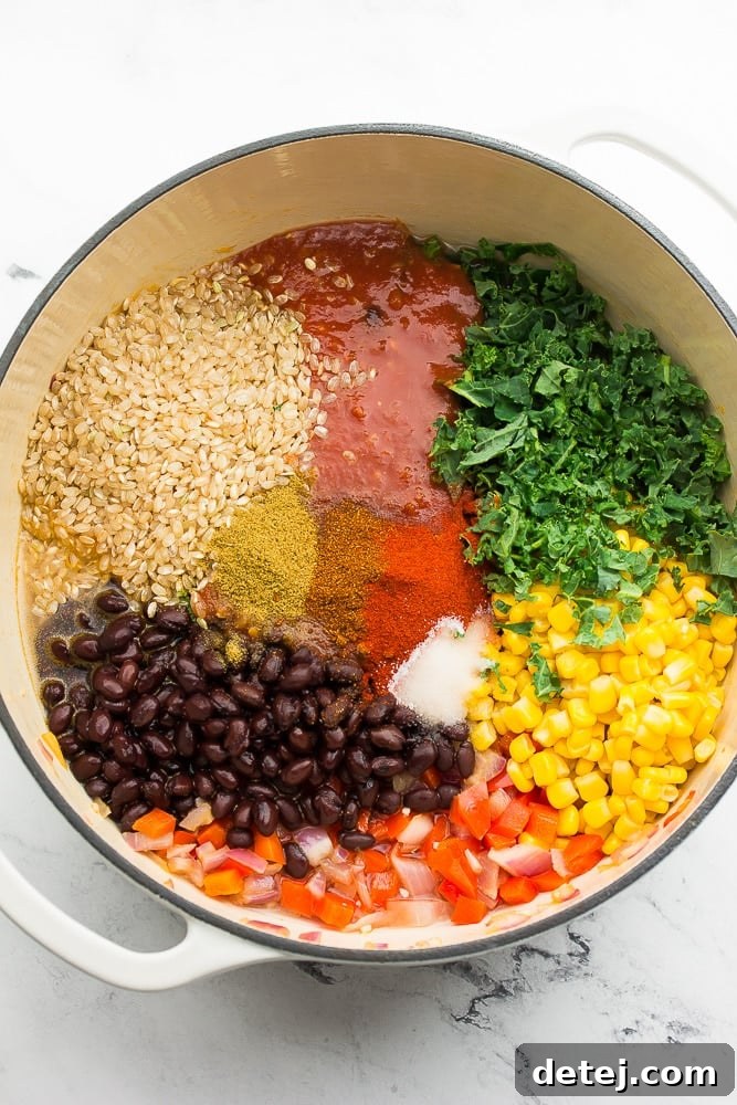 white pot with beans, rice, corn, salsa and more