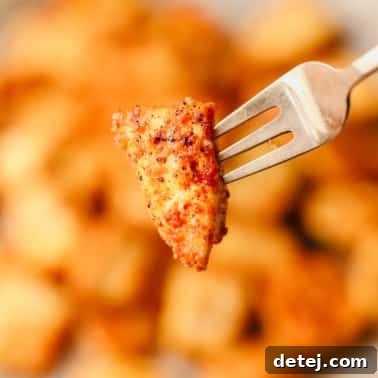 close up on a piece of crispy baked tofu on a metal fork.