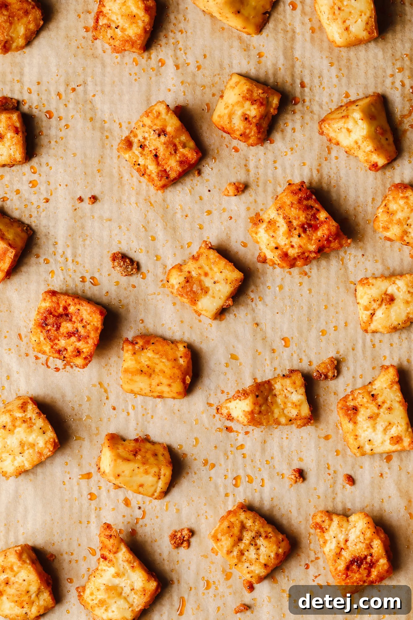 close up on baked tofu pieces on a baking sheet.
