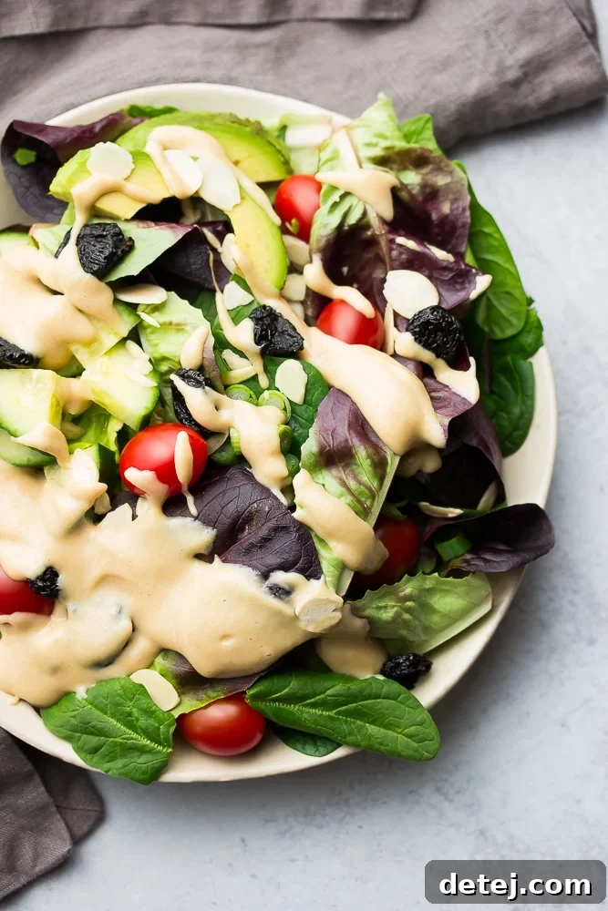 dark leafy greens salad with dressing and tomatoes