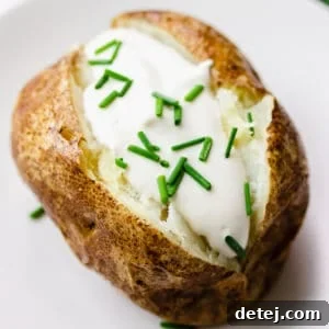 square image of a baked potato with vegan sour cream and chives
