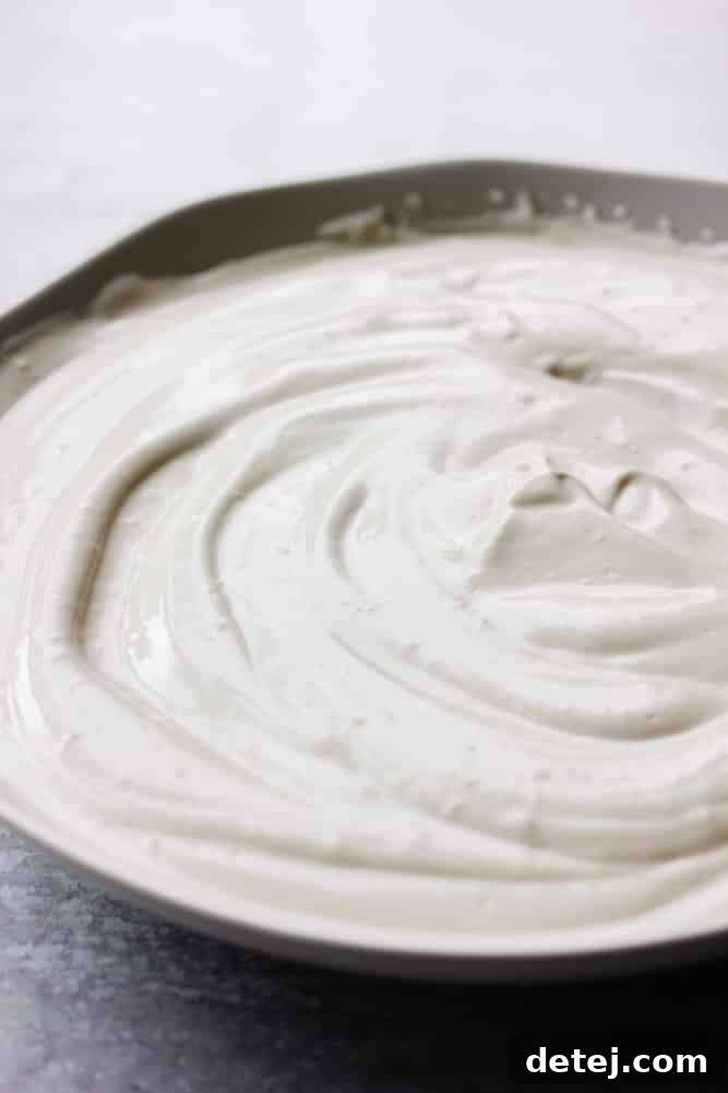 swirly bowl of white cream, grey background