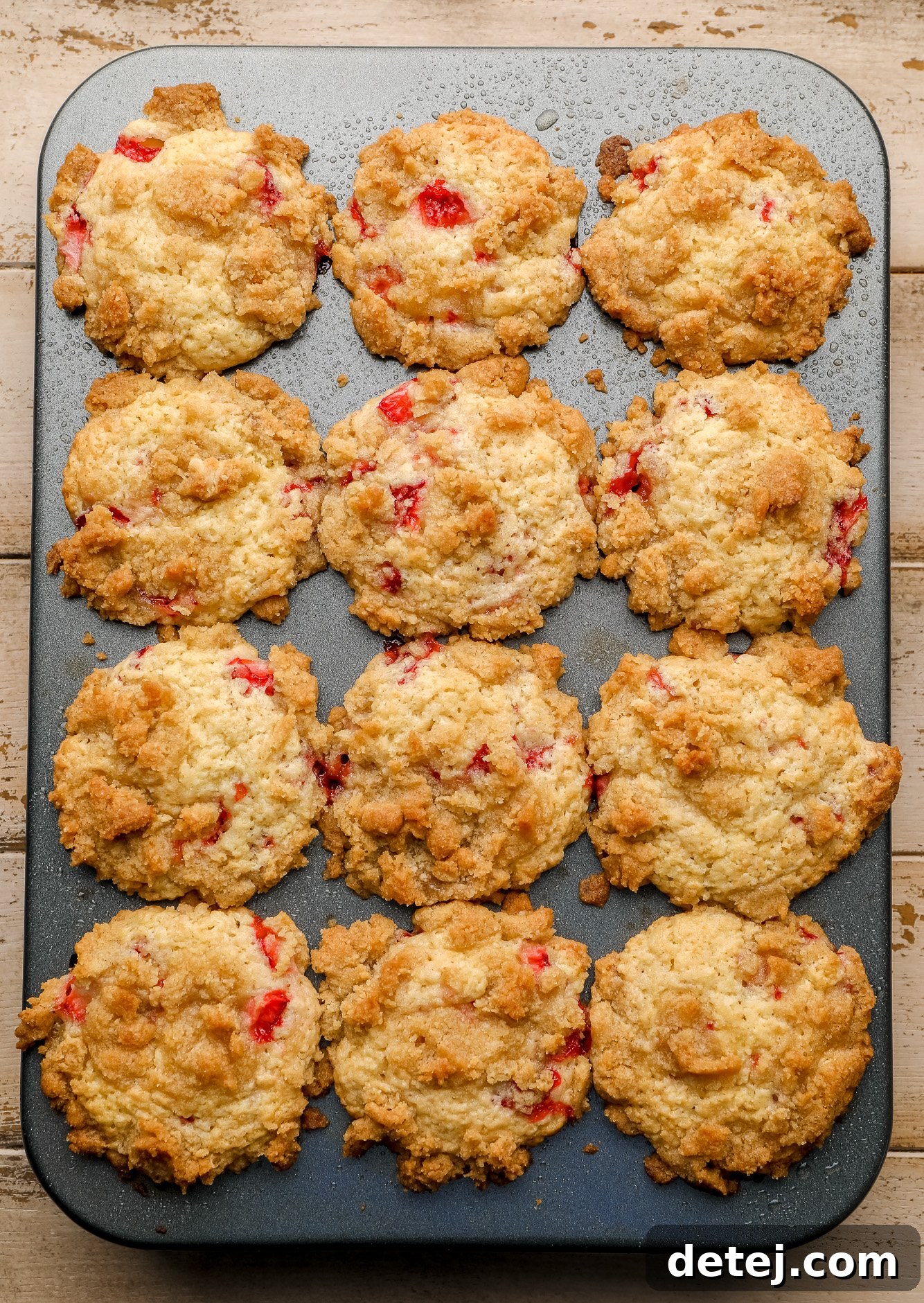 Luscious Vegan Strawberry Muffins 6 Baked vegan strawberry muffins still in the muffin tin, cooling slightly.