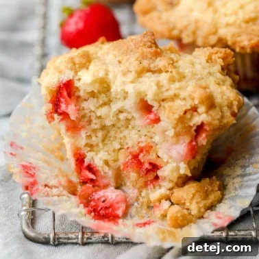 Close-up on a baked vegan strawberry muffin that's been split in half.