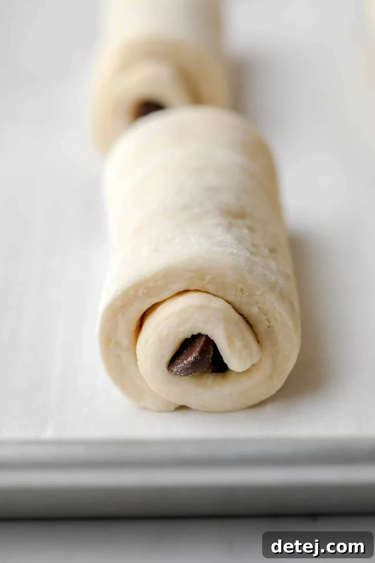 Vegan Chocolate Croissant Perfection 6 rolled chocolate filled pastry unbaked on a parchment lined pan