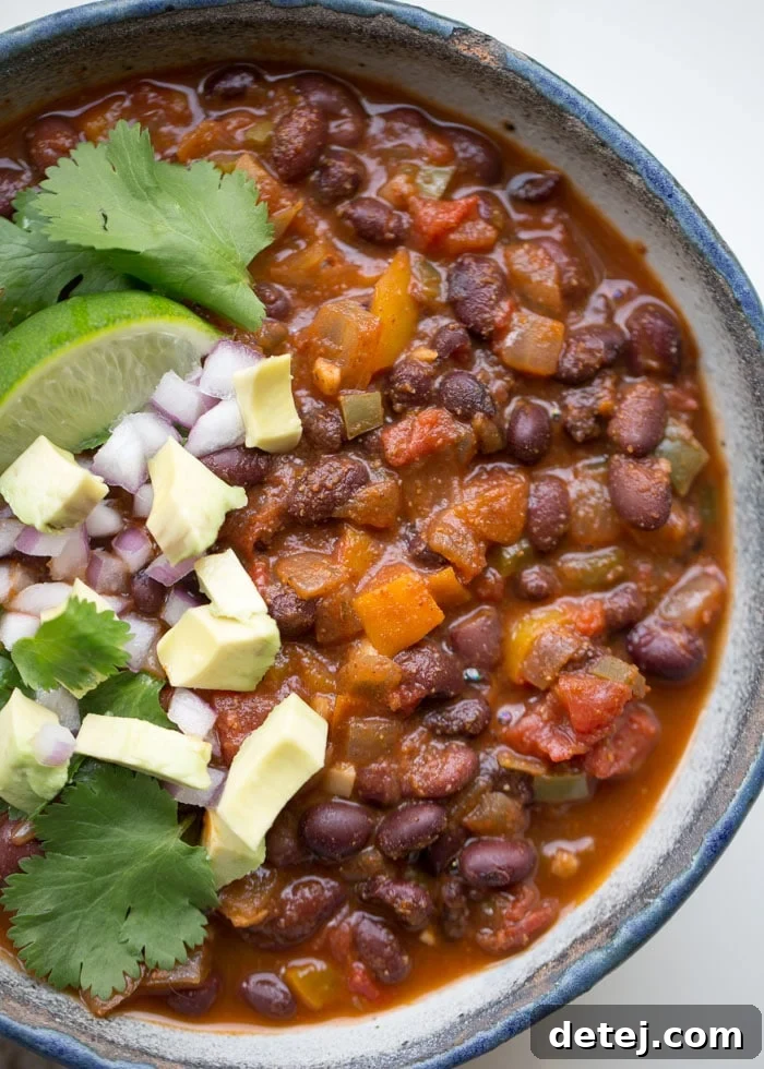 25 Effortless Vegetarian Instant Pot Creations 16 Close up of Simple Instant Pot Vegan Black Bean Chili, garnished with fresh herbs