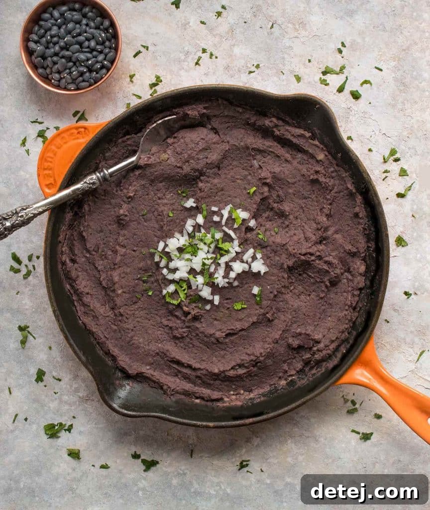 25 Effortless Vegetarian Instant Pot Creations 24 Instant Pot Refried Black Beans in a bowl, perfect for tacos or burritos