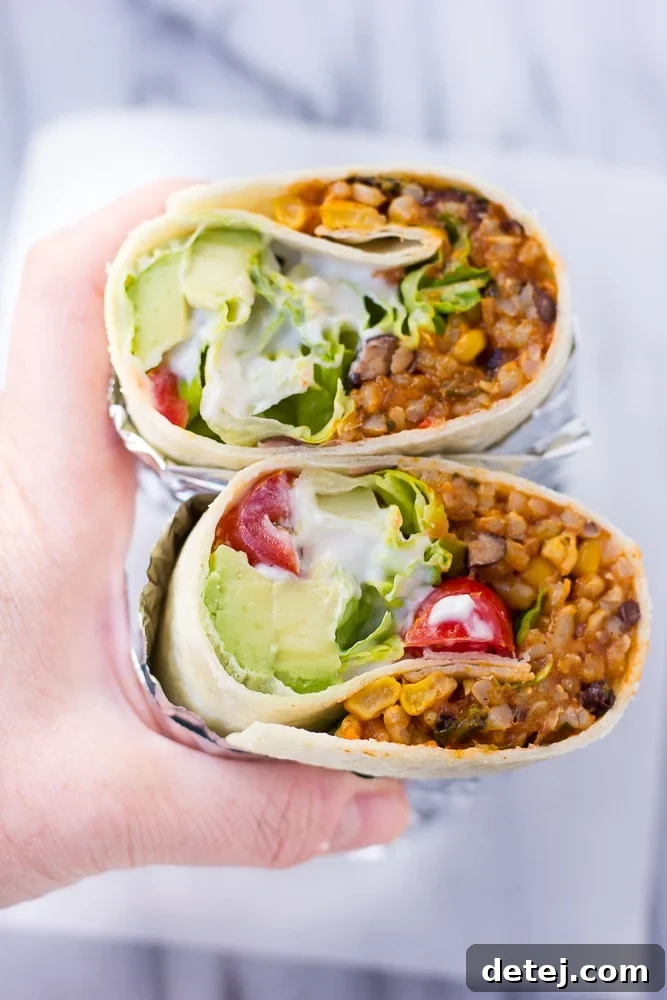 25 Effortless Vegetarian Instant Pot Creations 3 Instant Pot Vegan Burritos in hands, filled with rice, beans, and fresh toppings