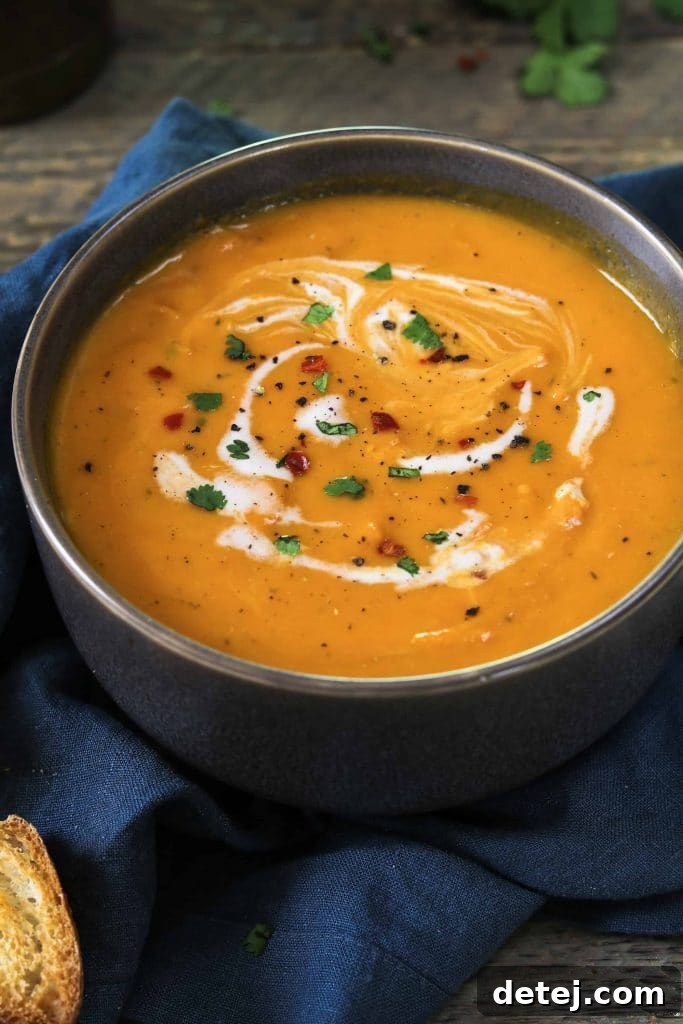 25 Effortless Vegetarian Instant Pot Creations 18 Vibrant Vegan Carrot Ginger Soup in a bowl with a spoon