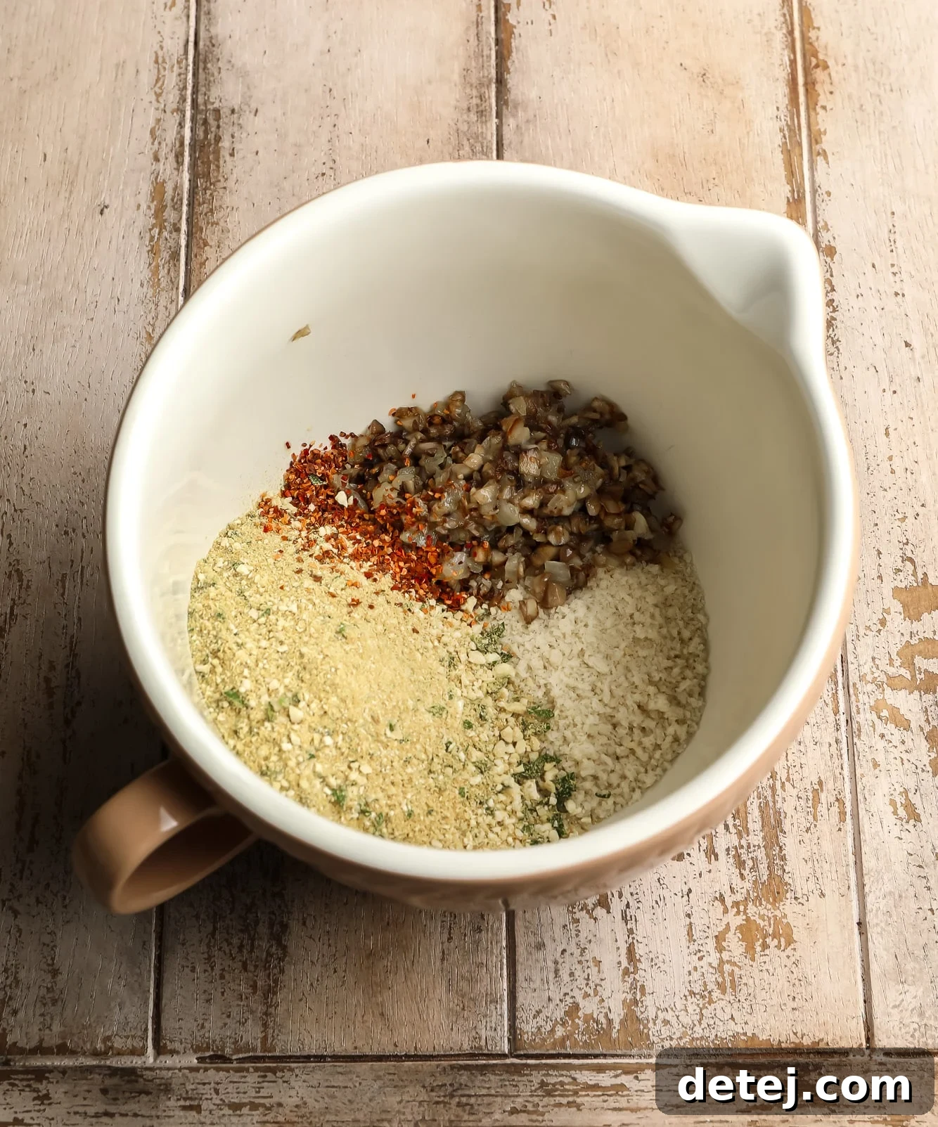 Savory Vegan Mushroom Delights 5 ingredients for stuffed mushroom filling in a white bowl.