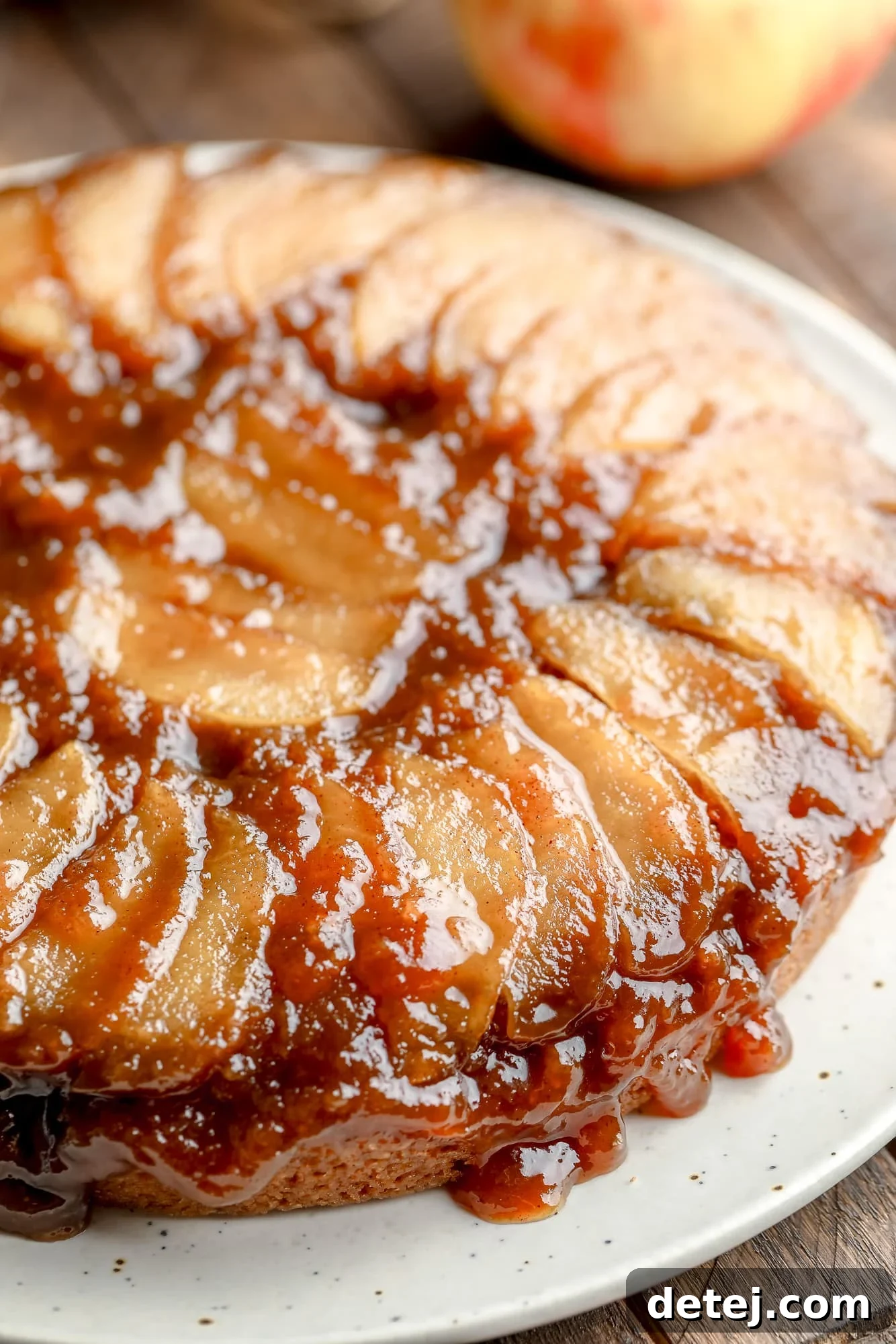 Close up on a baked Apple Upside Down Cake, showing the golden-brown caramelized apples on top and the soft cake texture.