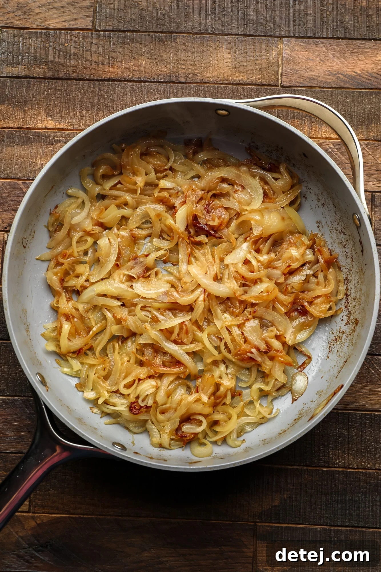 caramelized onions in a large grey skillet.