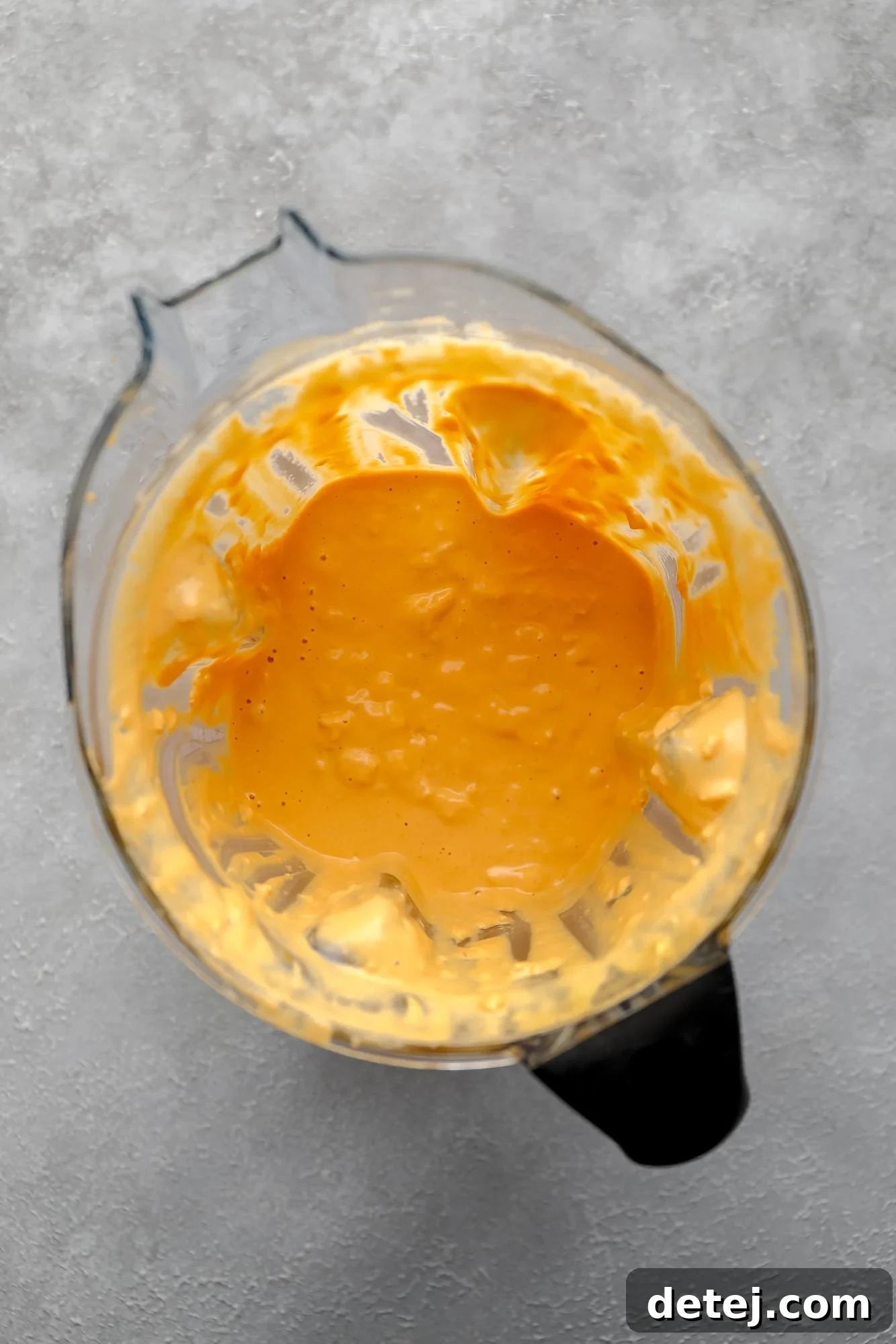 Creamy Vegan Buffalo Mac and Cheeze 4 creamy orange vegan buffalo cheese sauce in a blender.