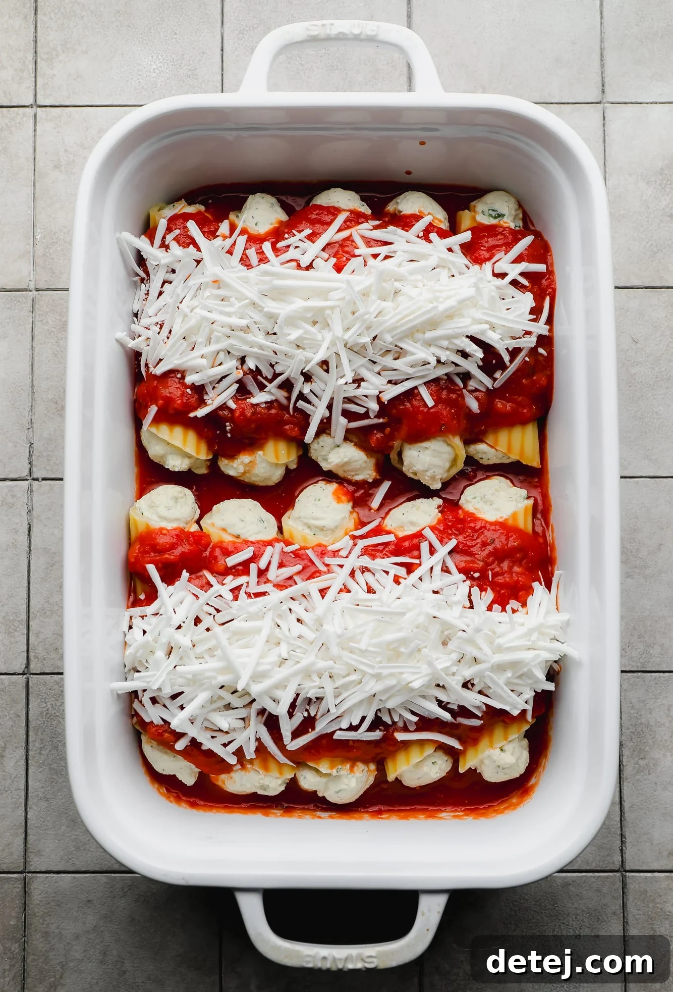 Plant-Based Manicotti 4 assembled and unbaked Vegan Manicotti in a white baking dish.