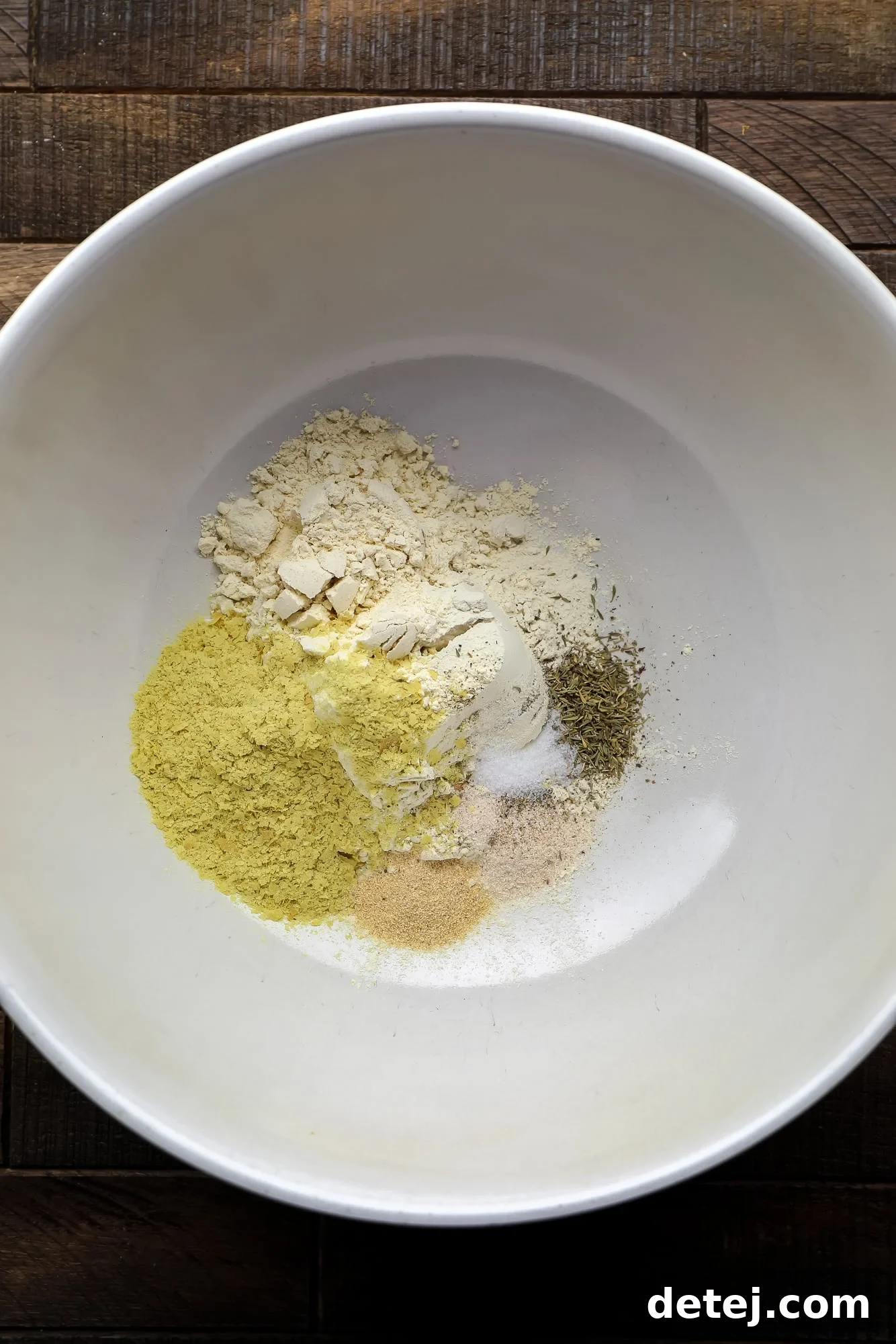 Effortless Seitan 3 dry ingredients for seitan in a large white bowl.