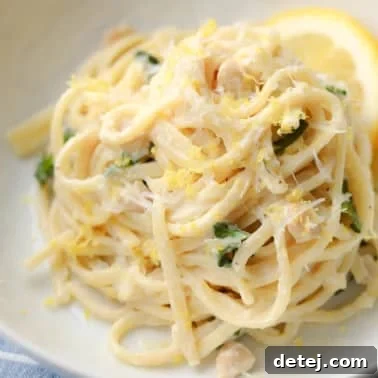 close up on creamy lemon pasta in a white bowl.
