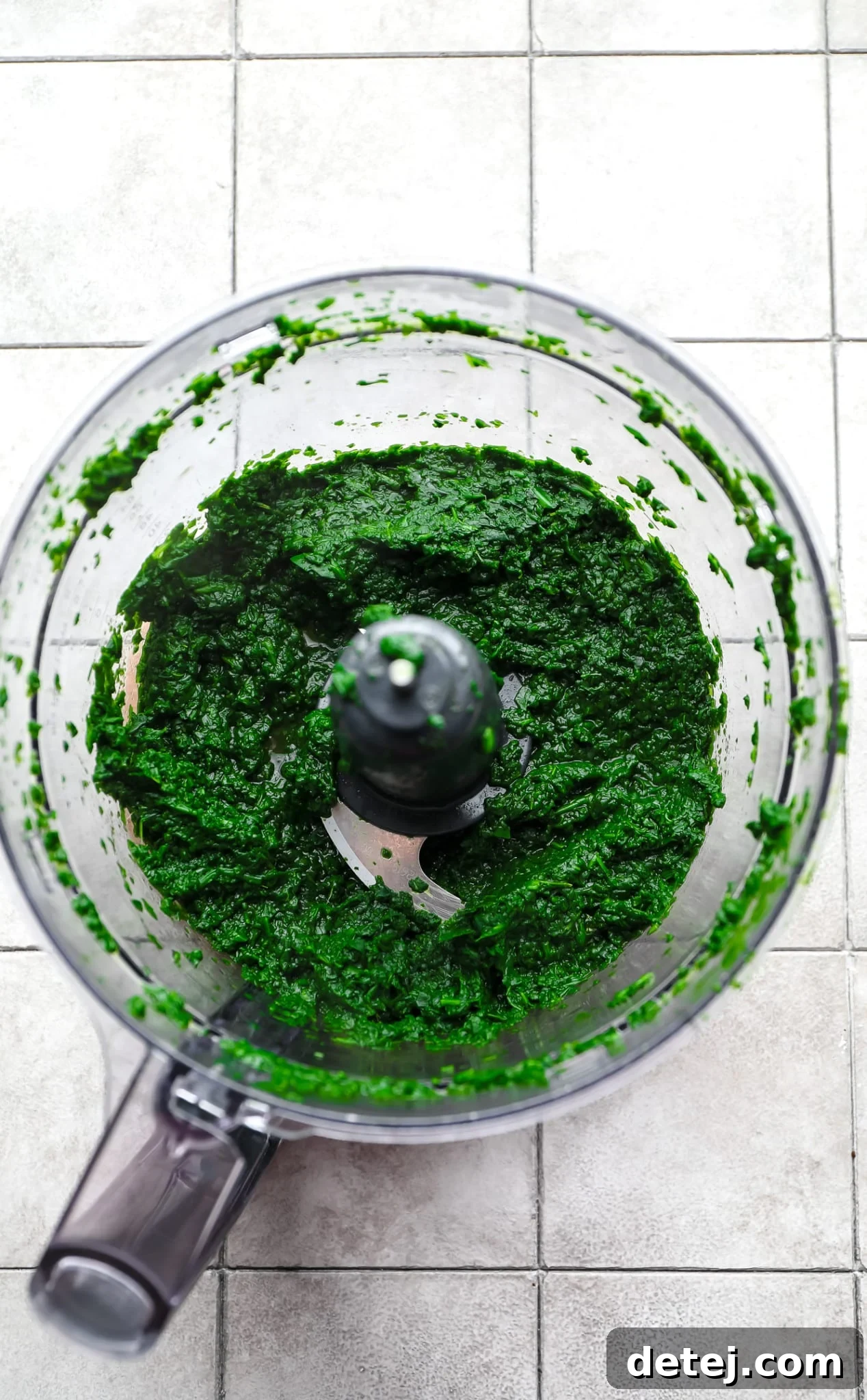 Blended spinach in a food processor, ready to be incorporated into the curry.