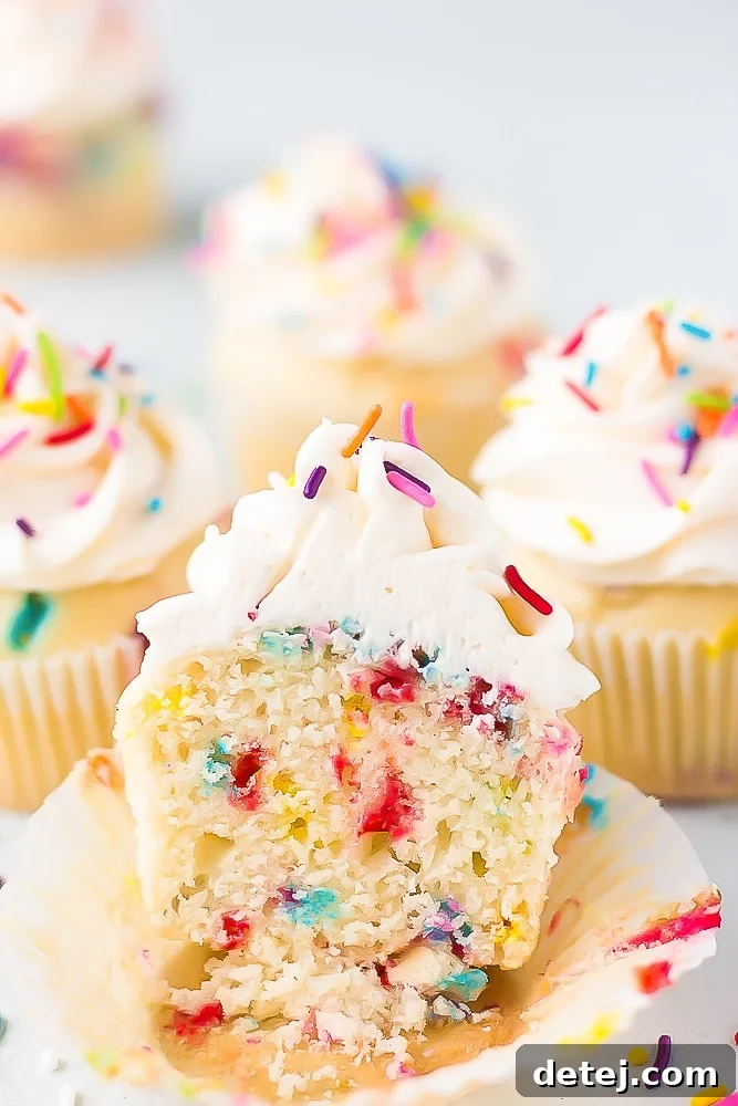 showing the middle of a cut cupcake with sprinkles